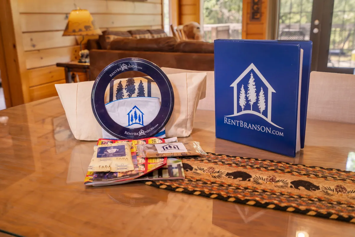 An interior scene featuring a decorative plate with a logo, an information binder, and assorted brochures laid out on a table runner. This setting communicates helpful resources for exploring local attractions, enhancing the sense of being tech-savvy and well-prepared.